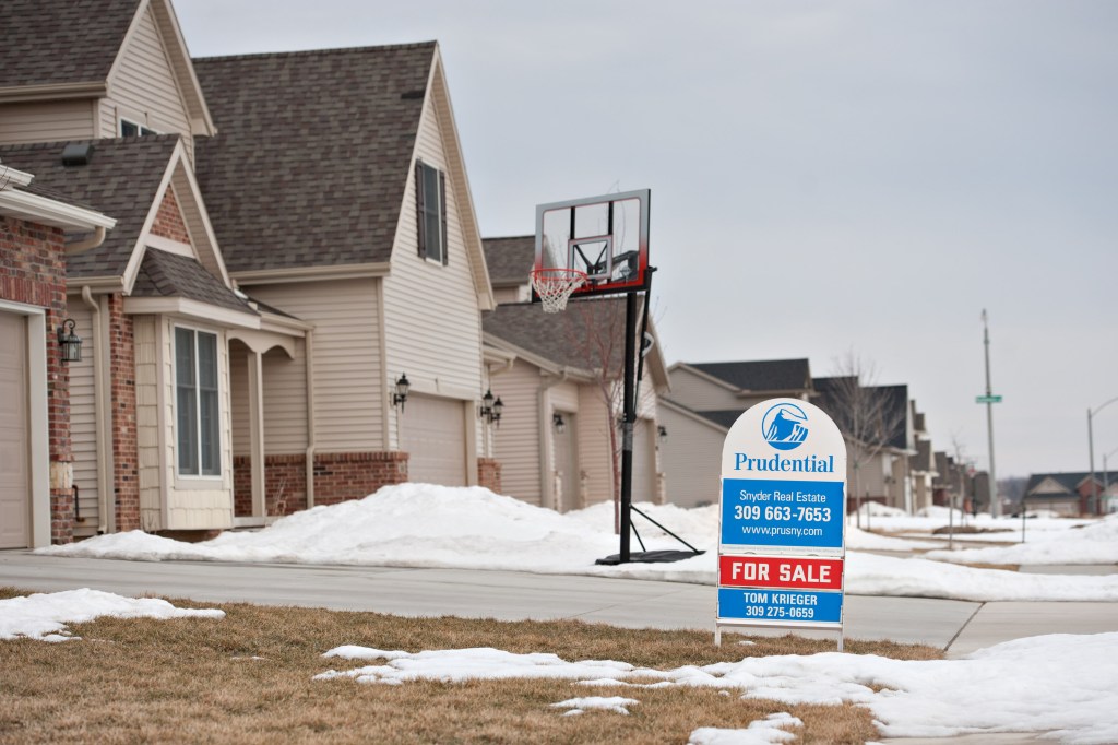 A for sale sign stands outside a new home in Bloomington, Illinois, US, Tuesday, Feb. 15, 2011.